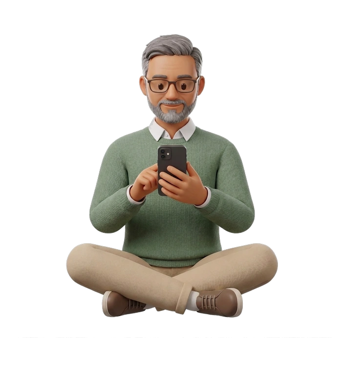 a man in reading glasses sitting cross-legged, looking at his phone